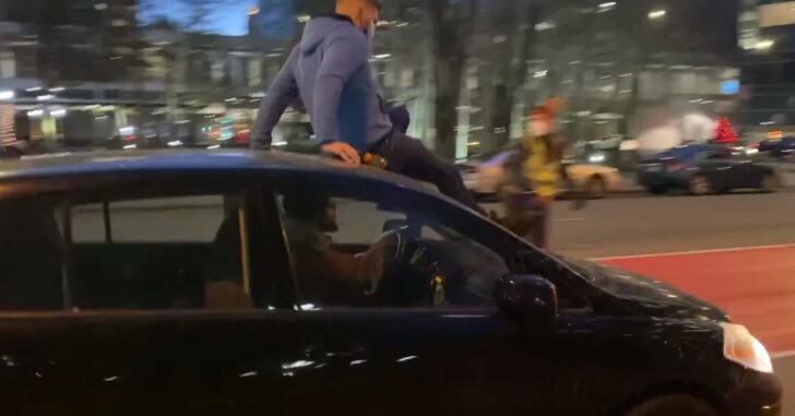 Vehicle Drives Through Crowd Protesting In Minneapolis, Guy On Roof Decides He Wants Down