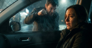 Man outside car, woman inside.